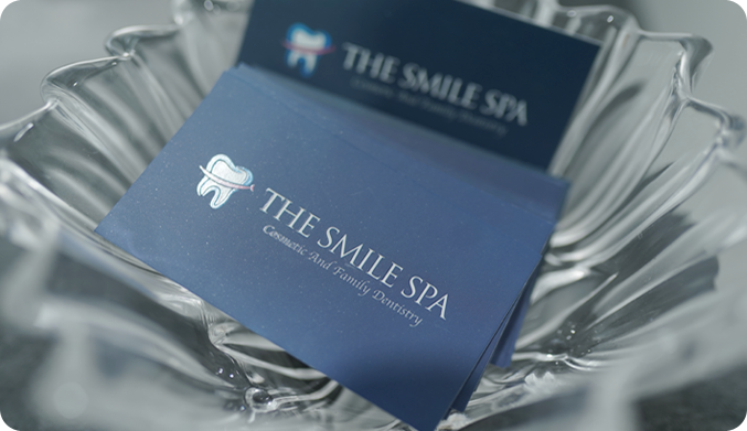 The smile spa dental clinic mumbai visiting card at the front desk