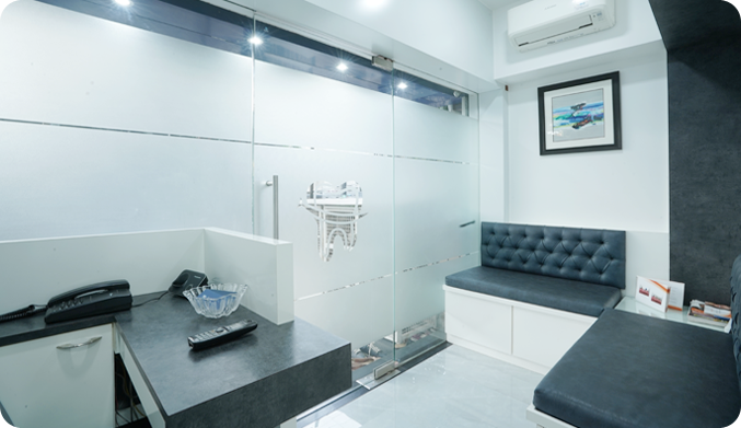 Dental clinic waiting lobby/area with sofa, AC and reception desk